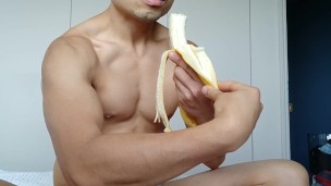 eating a banana - though not quite big enough for this flexing muscle hunk
