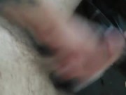 In a parking lot in front of a gas station playing with my hard cock