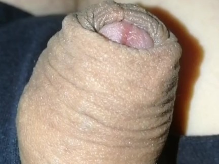 Grower slowly erects, no hands flaccid, foreskin with pre-cum drop at end.