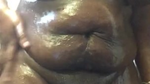 Oiled Up Ebony Plays With Her Tits