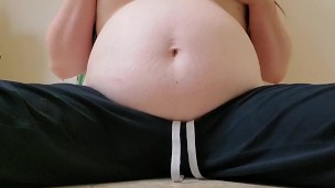 BELLY. Mom tugs on her swollen tits