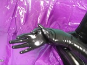 Putting on shiny black latex rubber gloves