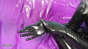 Putting on shiny black latex rubber gloves