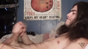 with long hair strokes his big cock to huge load