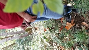 Guy taking a piss in the woods