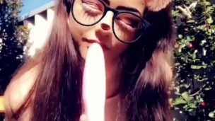 Slutty teen sucks a dildo outside