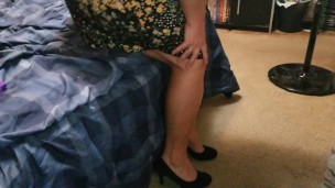 Sexy wife dangling high heels crossing legs adjusting skirt