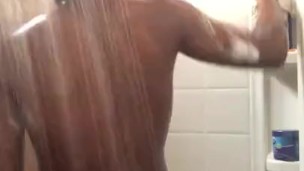 Black teen plays with big dick and fat ass while showering 