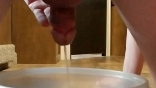 Pissing in a bowl on all fours.
