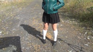 Schoolgirl in white knee socks and black shoes under the skirt