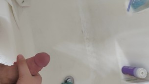 Young cock shooting cum into the shower