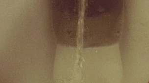 Close-up hairy pussy pissing on public toilet after holding 
