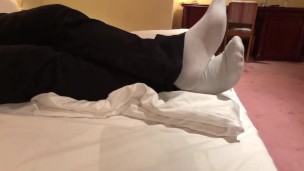 Male dress shoes, nikes, globes and white socks shoeplay in a nice hotel