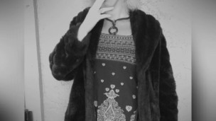 Smoking in fur coat.
