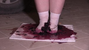 Plump legs in white socks mercilessly trample grapes. Crush fetish