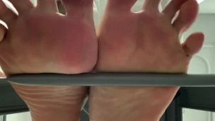 My bare soles from under a barstool 