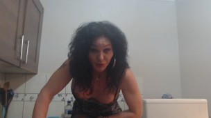 Mature trans sitting in the kitchen playing with his /her cock