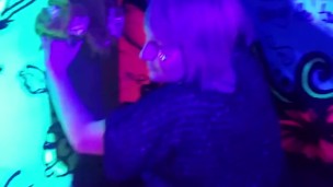 Sexy chick dancing, booty poppin in black light room.
