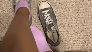 Teen girl takes shoes off after class 