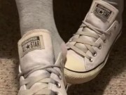 Ebony teen taking off sweaty shoes after class