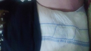 Chubby boy wets his diaper and spanks his padded crotch