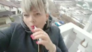 Hot pink lips smoking balcony
