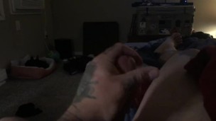 Tattooed guy stroking big cock till he cums