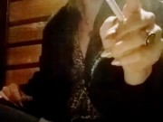 Smoking a cigarette alone.