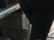Candid following sexy cougar MILF in tight yoga pants who teases her ass