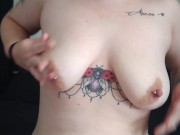 Tattooed girl plays with pierced boobies