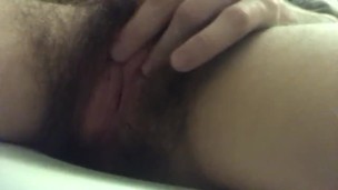 Hair pussy masturbates up close