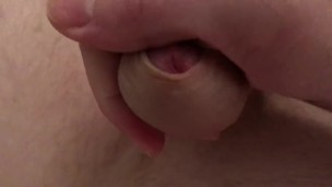 Guy plays with his balls and strokes his cock until he cums on himself 