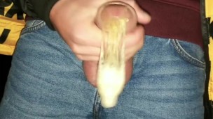 Twink fills cum filled condom even more public