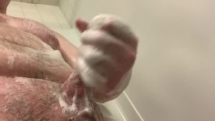 Husky guy rubs his cock in the shower 