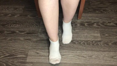 STUDENT GIRL SHOWS WHITE SOCKS AND FEET AFTER STUDYING.