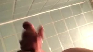 Stroking semi hard cock in the dorm shower