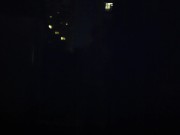 Blond guy spins fire on rooftop in socks and underwear 1/16