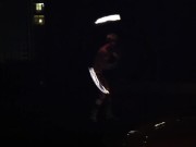 Blond guy spins fire on rooftop in socks and underwear 10/16