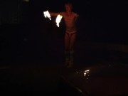 Blond guy spins fire on rooftop in socks and underwear 16/16