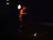 Blond guy spins fire on rooftop in socks and underwear 5/16