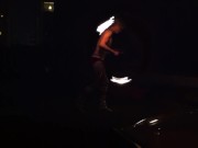 Blond guy spins fire on rooftop in socks and underwear 7/16