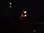 Blond guy spins fire on rooftop in socks and underwear 8/16