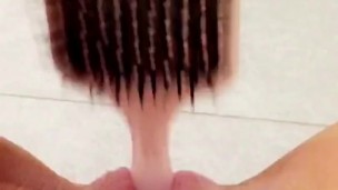 Naughty teen fucks her tiny pussy with hairbrush in school bathroom