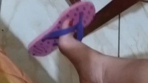 tici feet @tici_feet tici_feet dangling pink havaianas, red toenails