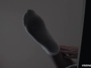 Legs in white socks on the table