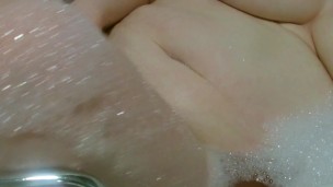 having a rub in a bubble bath