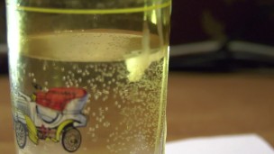 Russian cock cums in a glass and sperm blobs drowns in water; english text