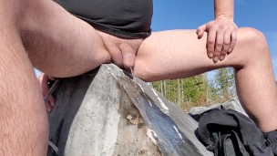 Pissing on a big rock with no pants on