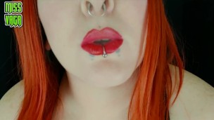 Smoking redhead with piercings and red lipstick Miss Vaga