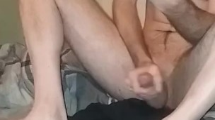 Sitting on the pillow looking at my tablet and stroking big dick! 